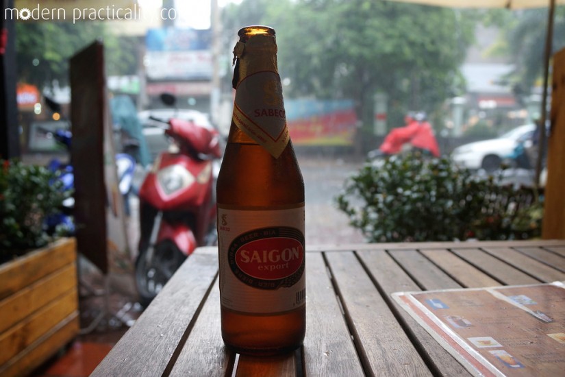 Enjoying a Saigon beer while we wait out a rainstorm.