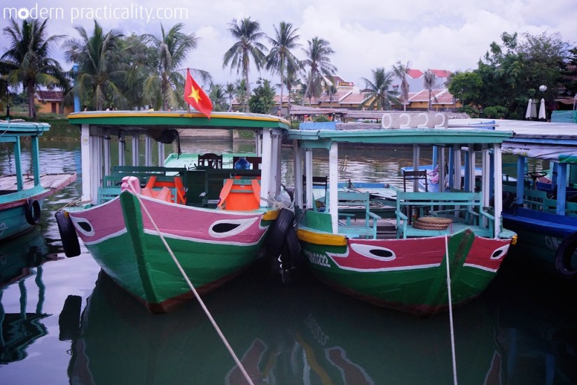A row of vibrantly painted boats on the Thu Bon River.